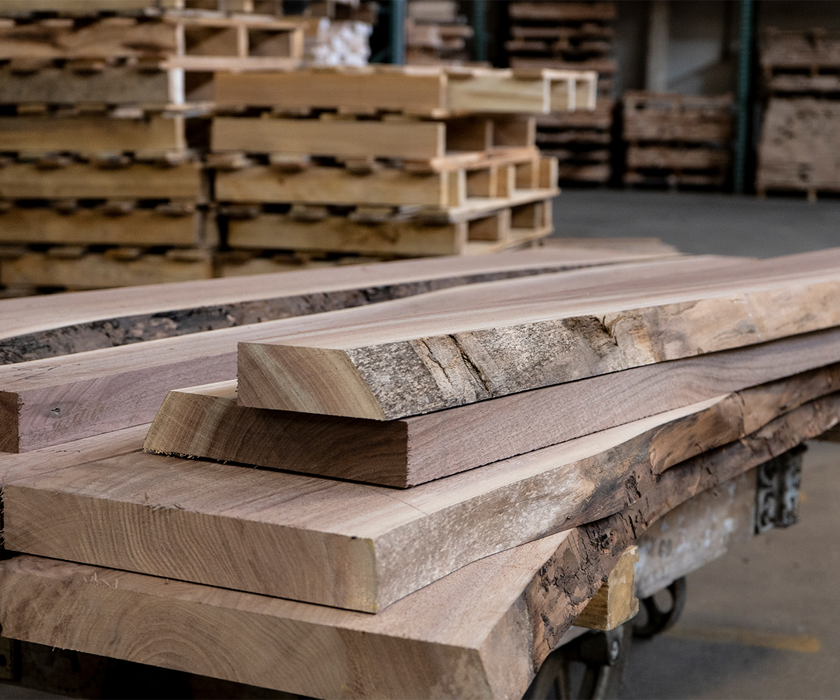 Hardwood lumber boards stacked in a furniture workshop